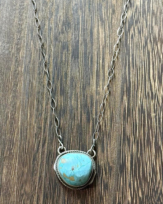 This exquisite 20" chain features a handcrafted pendant adorned with a captivating Kingman Turquoise stone. Designed by Navajo Jewelry Designers.