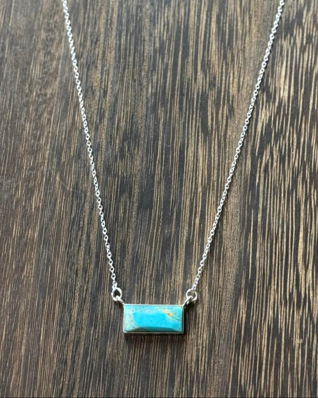 The vibrant blue turquoise bar pendant hangs gracefully from a 16" sterling silver chain, complete with a 2" extender for adjustable length. 