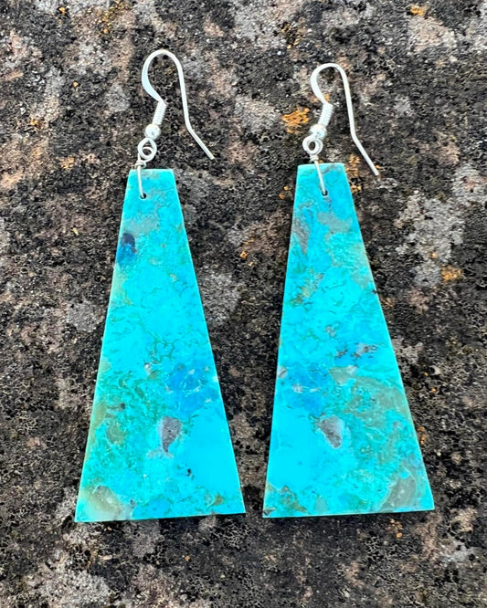 Hand-cut turquoise slab earrings with natural veining and a sky-blue color.