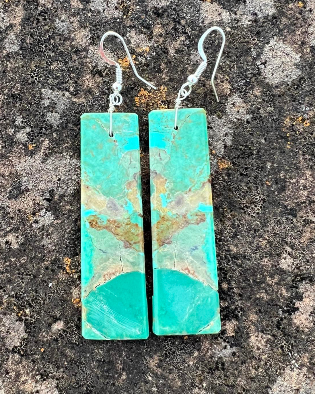 Hand-cut turquoise slab earrings with smooth, rounded edges and bright blue hues.